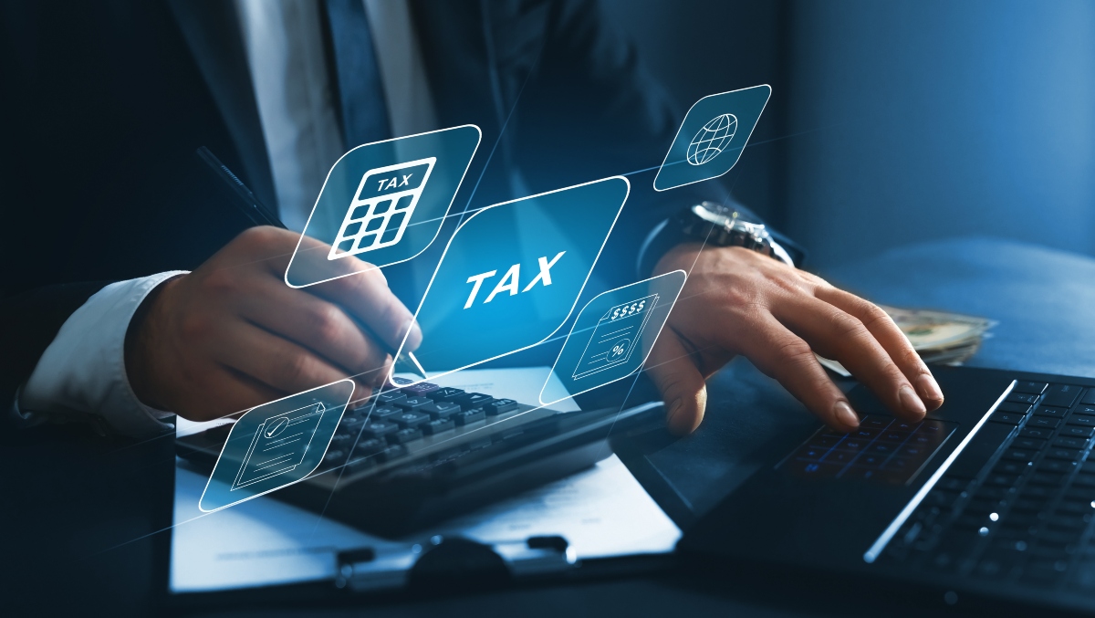 Business professional calculating taxes with a calculator and digital tax-related icons, representing IRS audit processes and tax preparation.